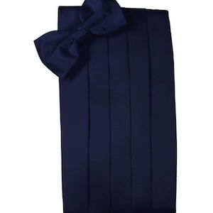 May include: A navy blue satin bow tie and matching cummerbund. The bow tie is pre-tied and the cummerbund has five pleats.