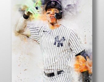 May include: A watercolor painting of a baseball player wearing a white and black striped jersey with the New York Yankees logo. The player is raising his right arm in the air, wearing a green glove. The background is a light gray with splashes of color.
