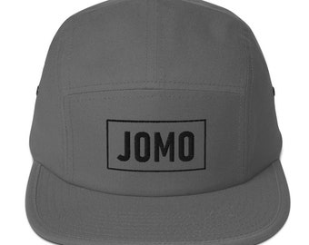 May include: A gray 5-panel cap with a black rectangular patch that says "JOMO" in all caps.