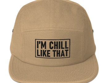 May include: A tan 5-panel cap with a black embroidered box that says "I'M CHILL LIKE THAT".