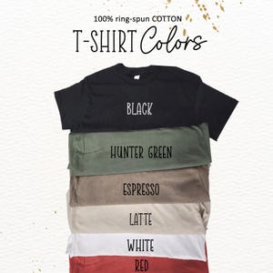 A stack of various colored T-shirts, with each shirt having a different color label.