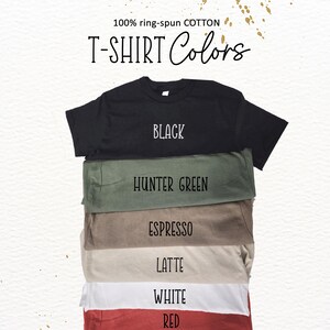 A stack of various colored T-shirts, with each shirt having a different color label.