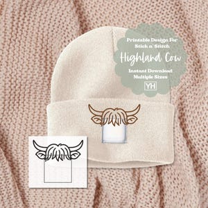 May include: A cream-colored beanie featuring a Highland cow design. The design includes a brown outline of the cow's head and horns. The image also shows a printable design for stick and stitch, with the text "Highland Cow" and "Instant Download".