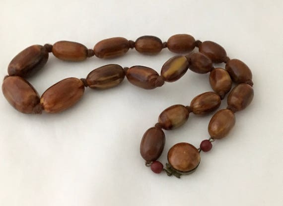 Brown hand knotted flame necklace on Bakelite bead