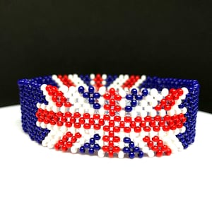 May include: A beaded bracelet with a red, white, and blue design that resembles the Union Jack flag.