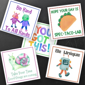 May include: A collection of square watercolor art prints with positive messages and whimsical illustrations. The prints feature phrases like "Be Kind," "You Got This!," and "Be Unique," along with images of a taco, snail, and robots.