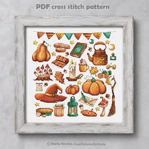 May include: A framed cross-stitch pattern featuring autumn-themed illustrations. The design includes pumpkins, a witch's hat, a teapot, a candle, and other fall-related items. The text "PDF cross stitch pattern" is at the top.
