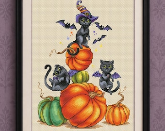 May include: A cross stitch pattern featuring three black cats and pumpkins. One cat wears a purple and yellow striped witch hat. Small purple bats fly around the cats. The text reads PDF cross stitch pattern, Maria Brovko, and CutePatternsByMaria.
