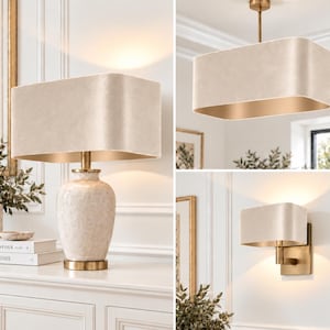 May include: A collection of lighting fixtures featuring a table lamp with a textured ceramic base, a pendant light, and a wall sconce. Each piece includes an oval-shaped, light beige fabric shade with a metallic gold interior lining and brass hardware.