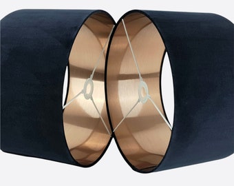 May include: Two lampshades, one black and one copper, are joined together. The black lampshade is made of fabric and the copper lampshade is made of metal.