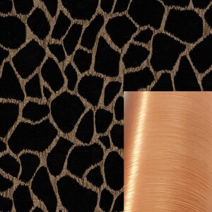 May include: Black fabric with a gold animal print pattern. A spool of peach-colored thread is shown to the right.