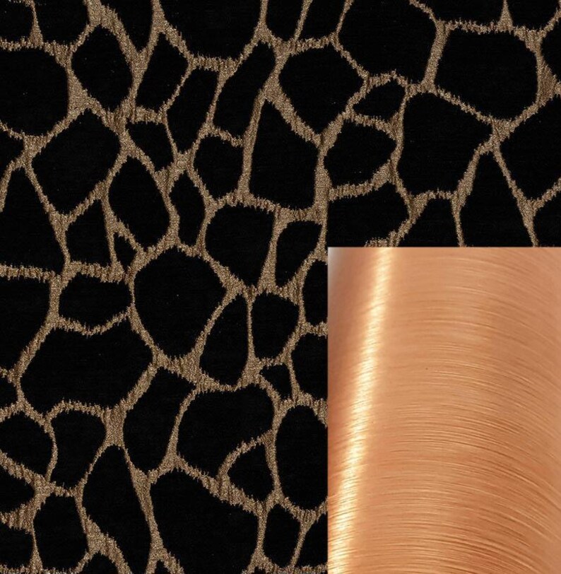 May include: Black fabric with a gold animal print pattern. A spool of peach-colored thread is shown to the right.
