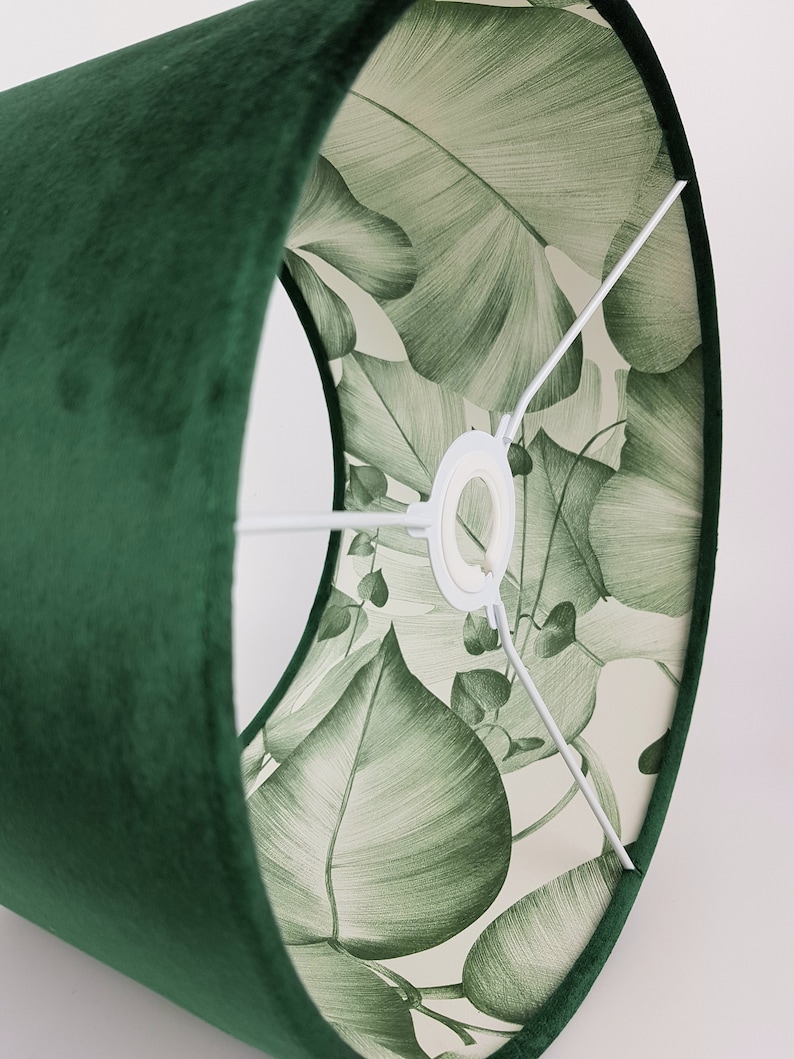 May include: A green velvet lampshade with a white lining featuring a green leaf pattern.