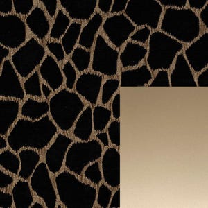 May include: Black fabric with a gold animal print pattern. The fabric is next to a solid gold colored surface.