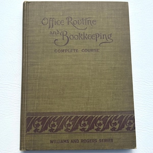 May include: A vintage book titled "Office Routine and Bookkeeping" with a complete course description. The cover is olive green with brown text and a decorative border. The book is part of the Williams and Rogers Series.
