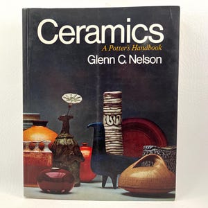 May include: A book cover titled "Ceramics" with the subtitle "A Potter's Handbook" by Glenn C. Nelson. The cover features a still life of various ceramic pieces in shades of red, orange, brown, and blue, including vases and decorative objects.