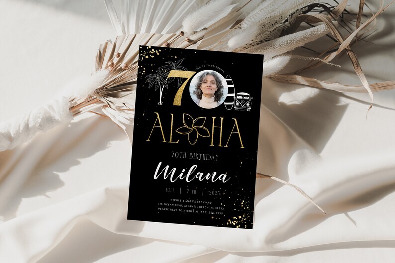 May include: Black and gold 70th birthday invitation with a photo of a woman in a circle. The invitation says "Aloha" and "70th Birthday" with the name "Milana" below. The invitation has a black and white beach scene with palm trees, a surfboard, and a van.