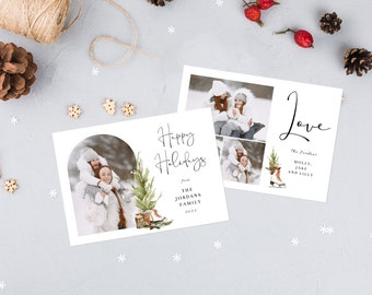 Può includere: Un biglietto di Natale con una foto di due persone in abbigliamento invernale. La carta presenta un'illustrazione ad acquerello di un pino e pattini da ghiaccio. Il testo sulla carta recita "Happy Holidays from The Jordans Family 2023" e "Love The Jordans Molly, Jake and Lilly".