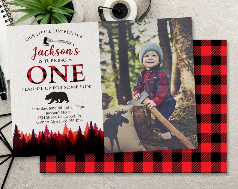 May include: A red and black plaid invitation for a first birthday party. The invitation features a photo of a young boy holding an axe, a silhouette of a moose, and a bear. The text on the invitation reads "Our Little Lumberjack Jackson's is turning one. Flannel up for some fun!"  Saturday, June 16th at 2:00pm Jackson's House 1234 Street, Kingwood, Tx RSVP to Alyssa 365-253-1754