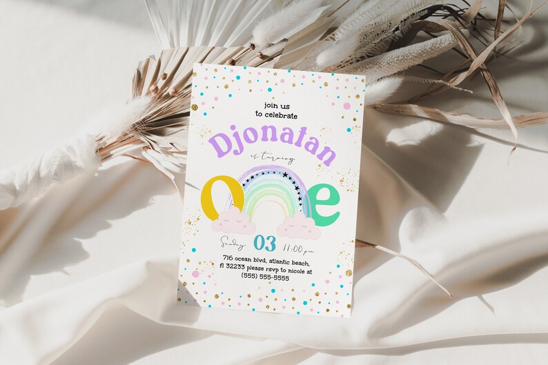 May include: A colorful invitation card with a rainbow, clouds, and stars. The text on the card reads "Join us to celebrate Djonatan is turning one. Saturday 03 11:00 pm 716 ocean bird, atlantic beach, 32233 please rsvp to nicole at (555) 555-6555"