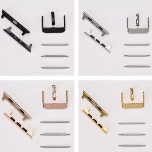 Pode incluir: Quatro conjuntos de adaptadores de banda para Apple Watch em preto, prata, ouro rosa e ouro. Cada conjunto inclui dois adaptadores de banda e três pinos de mola.