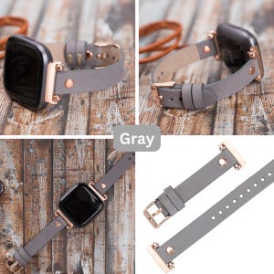 May include: A gray leather watch band with rose gold hardware. The band is shown in three different positions, including a close-up of the buckle and a view of the band on a watch.