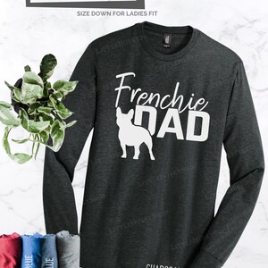 May include: Charcoal gray long-sleeve shirt with the text "Frenchie DAD" and a white French Bulldog graphic. The shirt is unisex and relaxed fit. Other colors are available upon request.