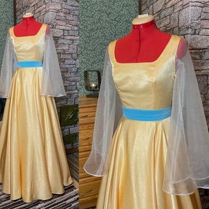 May include: A yellow satin dress with a blue sash and sheer white sleeves. The dress has a square neckline and a full skirt.
