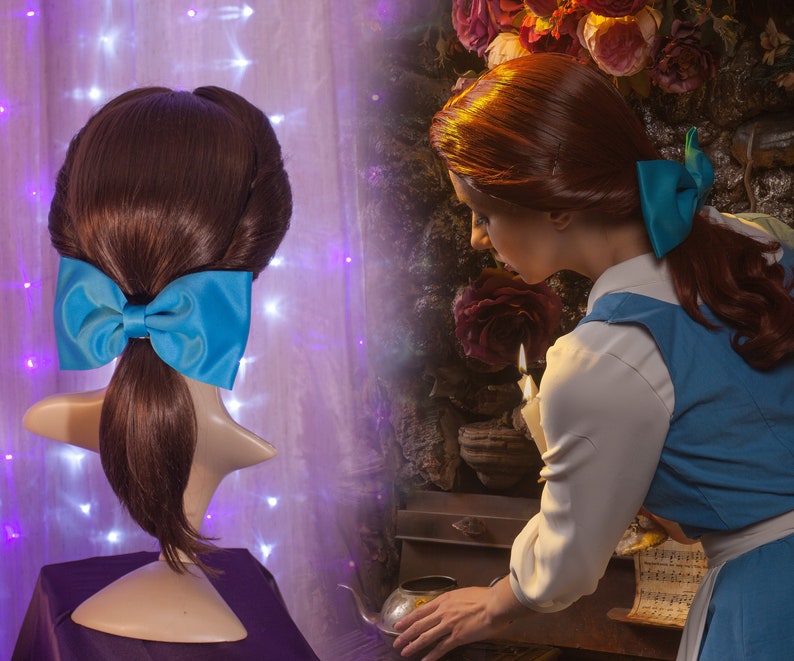 May include: A brown wig with a blue bow, styled in a ponytail with a bouffant. The wig is on a mannequin head. A woman with red hair is wearing a blue dress and a white blouse. She is holding a candle and looking at it.