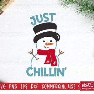 May include: A whimsical snowman illustration with a black top hat, orange carrot nose, and a red scarf. The text "JUST CHILLIN'" is in blue. The image is suitable for holiday-themed crafts.