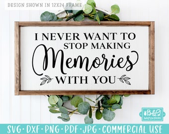 May include: A white wooden sign with black text that reads "I never want to stop making memories with you". The sign is framed in a dark wood frame and is decorated with small green leaves.