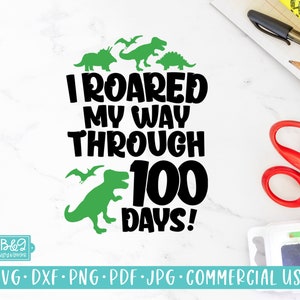 May include: A black and green graphic design with the text "I roared my way through 100 days!" surrounded by dinosaur silhouettes.