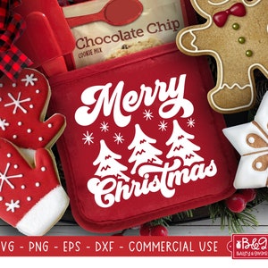 May include: Red oven mitt with white text that says "Merry Christmas" with three white stylized Christmas trees. The oven mitt is surrounded by gingerbread cookies, including a gingerbread man, a snowflake, and two mittens.