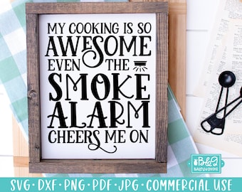 May include: A framed wooden sign with the text "MY COOKING IS SO AWESOME EVEN THE SMOKE ALARM CHEERS ME ON" in black lettering. The sign is on a white background and has a brown frame. The bottom of the sign has the text "SVG • DXF • PNG • PDF • JPG • COMMERCIAL USE".