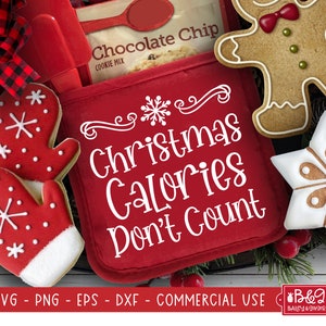 May include: Red oven mitt with white text that reads "Christmas Calories Don't Count". The oven mitt is surrounded by gingerbread cookies, including a gingerbread man, a snowflake, and two mittens.