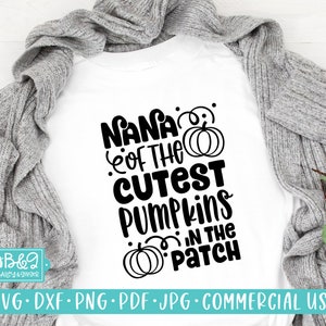 May include: A white t-shirt with black text that reads "Nana of the Cutest Pumpkins in the Patch" with a pumpkin graphic.