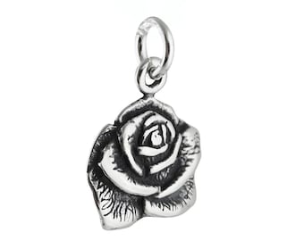 May include: A silver charm in the shape of a rose. The rose is detailed and realistic.