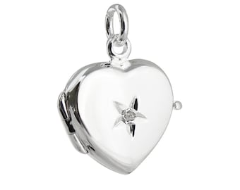 May include: A silver heart-shaped locket with a small diamond set in a star shape on the front.