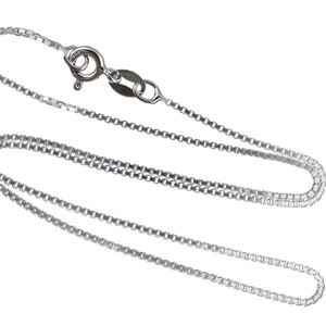 May include: A silver-colored box chain necklace with a lobster clasp. The chain is made of small, square links and is displayed against a white background. The necklace is a delicate piece of jewelry.