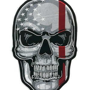May include: A black and white skull with a red stripe down the side. The skull is covered in a pattern of stars, resembling the American flag.