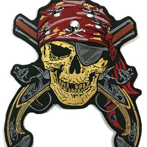 May include: A black and gold embroidered patch featuring a skull wearing a red bandana with skull and crossbones, a black eyepatch, and two crossed pistols.