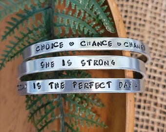 She is strong | Hand stamped aluminum cuffs