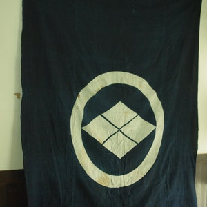 Indigo-dyed cotton cloth with family crest, circa Meiji era.