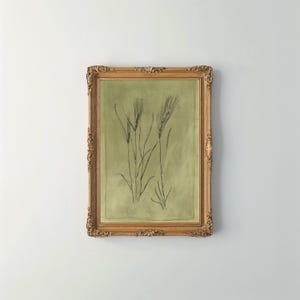 May include: A framed print of a botanical illustration of wheat stalks in black ink on a green background.