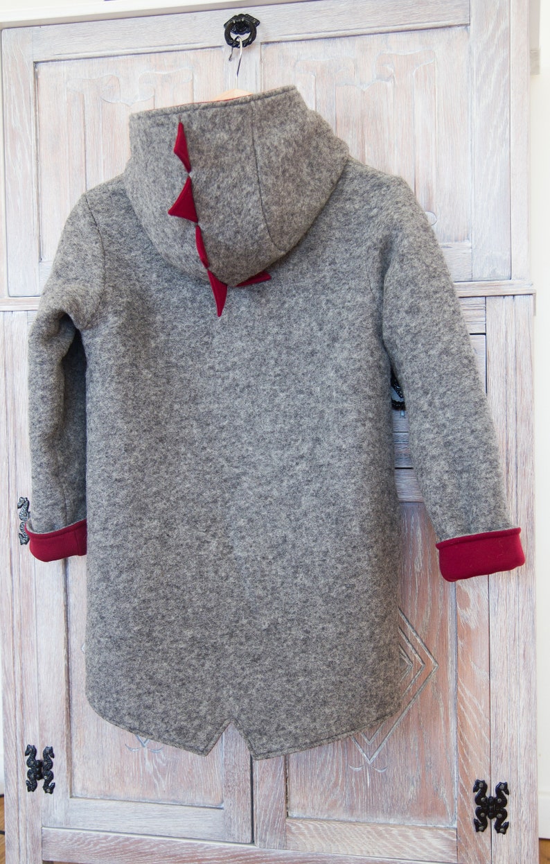 May include: Gray hooded jacket with red felt accents on the back and sleeves.