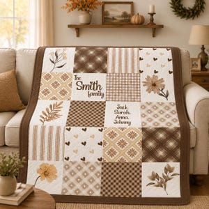 May include: A patchwork quilt with a brown border, featuring squares with floral, plaid, and striped patterns in shades of brown and cream. The quilt is personalized with "The Smith family" and names.