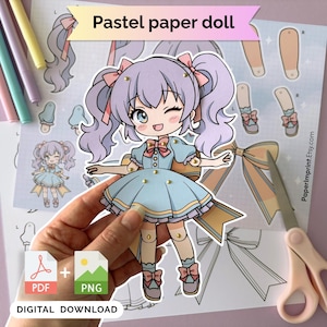 May include: A pastel paper doll with lavender hair in pigtails, wearing a light blue dress with pink bows and gold-colored brads at the joints. The doll is displayed against a printed sheet featuring additional doll parts, bows, and the text Pastel paper doll.