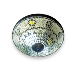 May include: A round, silver and black mosaic ceiling light fixture with a white light bulb.