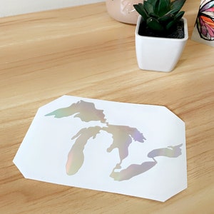 May include: A white vinyl sticker with a holographic finish depicting the outline of the Great Lakes.