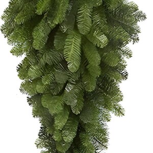 May include: A cascading, artificial evergreen garland with lush, dark green foliage. The garland features a dense arrangement of needle-like leaves, creating a full and textured appearance. Ideal for holiday decor or year-round greenery.